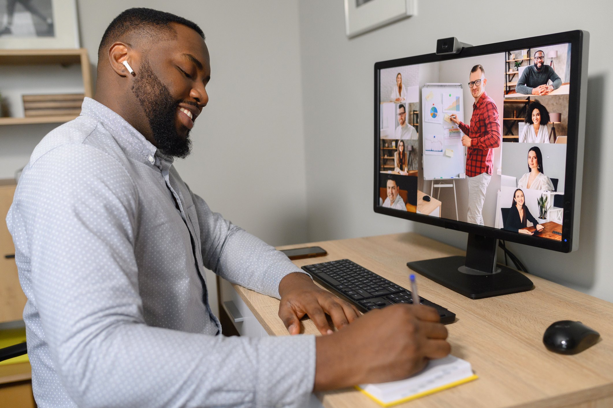 Man participating in a team meeting from home office